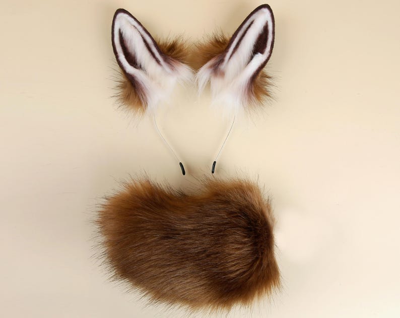 May include: A brown and white faux fur fox tail and a matching pair of fox ears with a headband.