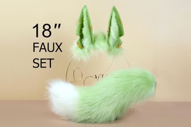 May include: 18" Faux Fur Tail and Ear Set. The set includes a green and white faux fur tail and a headband with two green faux fur ears.