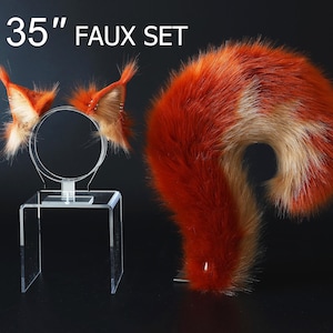 May include: A 35 inch faux fur tail set with a headband and a separate tail. The headband has two orange and white fur ears. The tail is orange and white with a fluffy texture.