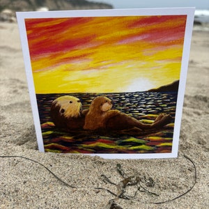 Tarjeta de felicitación para el día del padre, día de la madre, cumpleaños, todas las ocasiones, nutria marina, puesta de sol, interior en blanco