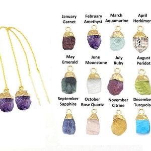 May include: A pair of gold dangle earrings with purple amethyst gemstone charms. The earrings are shown with a chart of different gemstone charms for each month of the year.