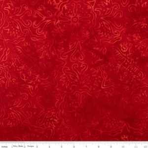 May include: Red fabric with a repeating, ornate pattern. The design features swirling, floral-like shapes in a slightly lighter shade of red. The fabric is measured in inches.