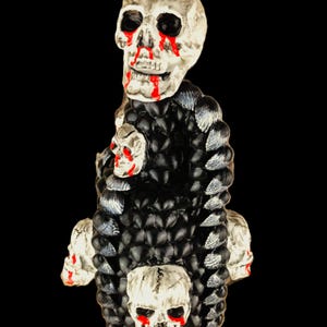 Unique handle bottle with beautiful details, decorated with hand-painted shells and skulls
