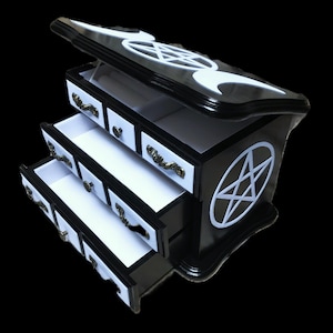Small wooden jewelry cabinet, a vintage piece of furniture in black, decorated with white velvet