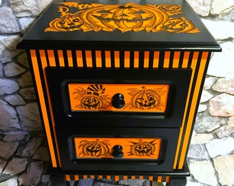 Wooden bedside table with two drawers, in a Halloween decor with hand-painted velvet