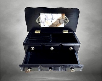 Small, black vintage wooden jewelry cabinet with a mirror