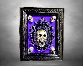 3D wall decor featuring skulls, hand-painted and adorned with purple velvet