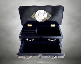 Small, black vintage wooden jewelry cabinet with a mirror