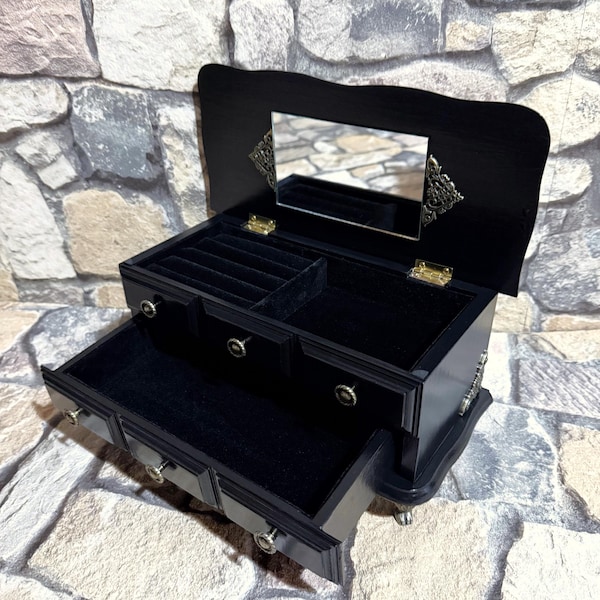 Small jewelry cabinet made of solid wood, a vintage piece of furniture with beautiful details in a new, elegant design