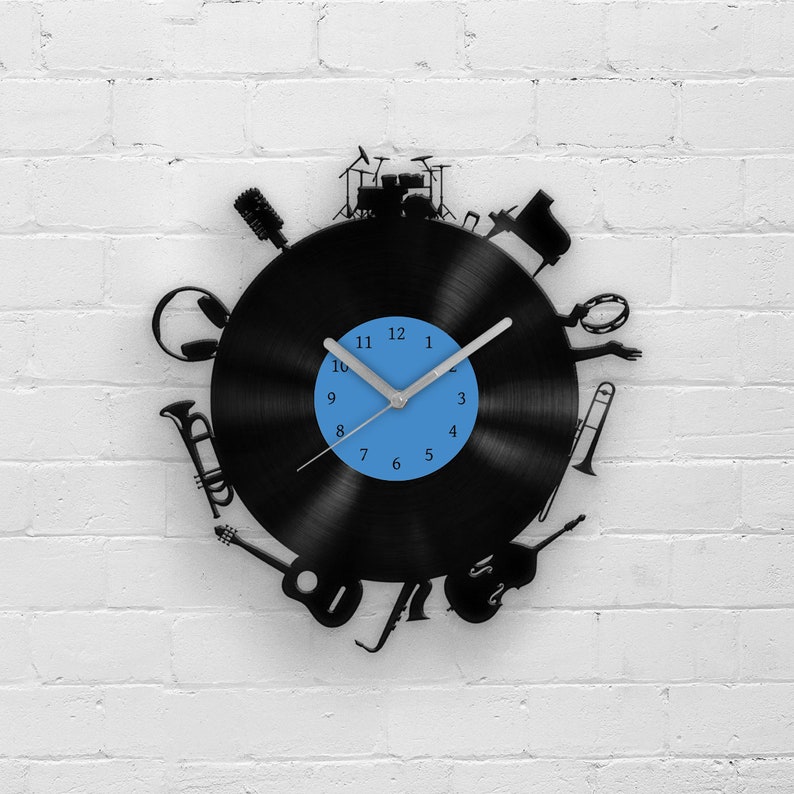 a wall clock that has a vinyl record disc shape and musical instruments in black color is the best gift for men who is a music fan