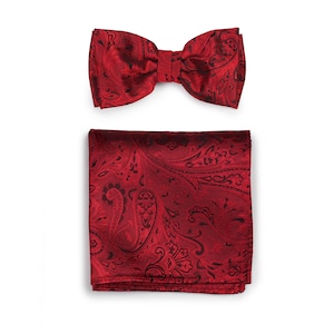 May include: A red paisley bow tie and pocket square set. The bow tie and pocket square feature a black paisley pattern.