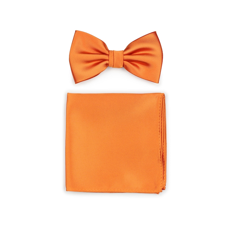May include: A set of orange satin bow tie and pocket square. The bow tie is pre-tied and the pocket square is a solid color.