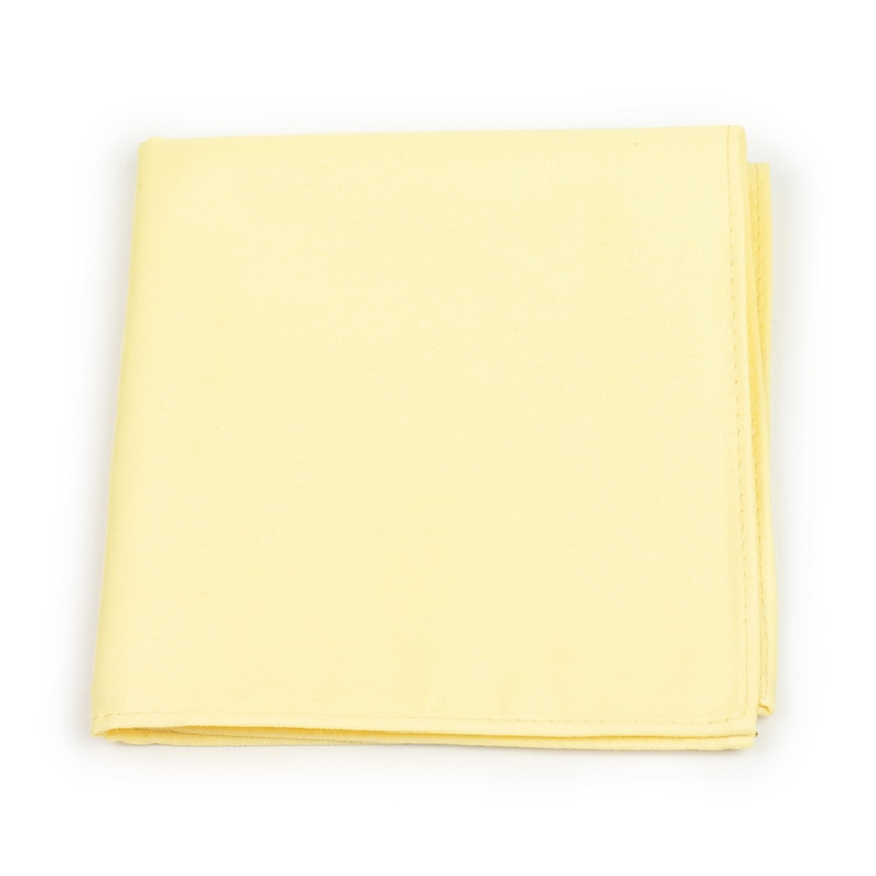 May include: A pale yellow fabric handkerchief, folded and lying flat on a white background.