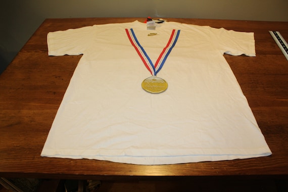 white red and gold nike shirt