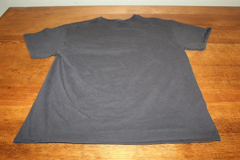 May include: A plain dark grey t-shirt with short sleeves.