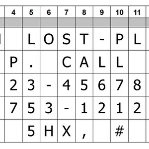 May include: A black and white grid with numbers 1 through 15 at the top and letters L1 through L5 on the left side. The grid contains letters and numbers, including the words "I'M LOST - PLEASE HELP. CALL DAD 07123 - 456789 OR 01753 - 121212 SL9 5HX, # 158".