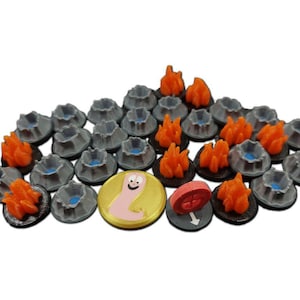 May include: A set of 20 game pieces, including 16 grey volcano tokens, 3 orange fire tokens, and 1 gold token with a cartoon worm. The gold token has the text "Shroom Queens" on it.