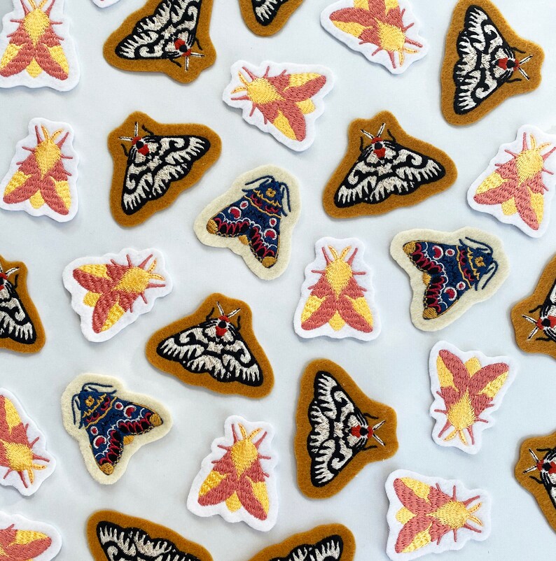 May include: A collection of embroidered moth patches in various colors and designs. The patches feature different moth species with intricate details, including wings, antennae, and bodies. The patches are perfect for adding a touch of whimsy and nature to clothing, bags, or other accessories.