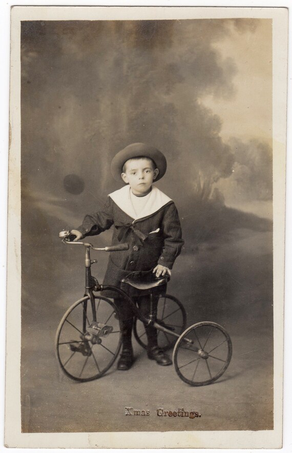 Vintage French postcard of young boy on his tricycle Vintage French postcard of young boy on his tricycle