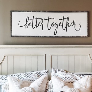 May include: A white wooden headboard with a sign above it that reads "better together" in black cursive lettering.