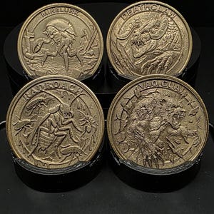 May include: Four antique gold-colored coins with detailed relief images. Each coin features a different creature: Mirelurk, Deathclaw, Radroach, and Yao Guai. The coins are displayed on a black surface, showcasing their intricate designs.