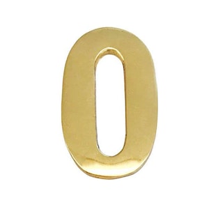 May include: A gold-colored metal number zero. The number is solid and has a smooth, shiny finish.