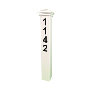 May include: White wooden post with black numbers 1142 on the front. The post has a square base and a decorative top.