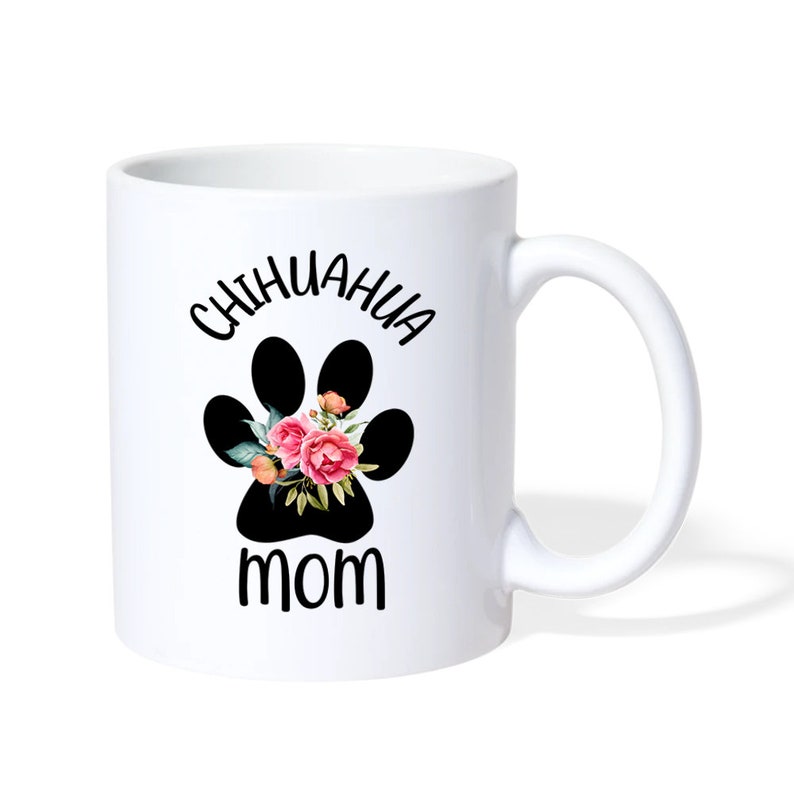 May include: White ceramic coffee mug with a black paw print with pink flowers and the text "Chihuahua Mom" in black.