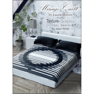 May include: A black and white quilt with a geometric pattern. The quilt is on a bed with black pillows. The quilt is called "Mirage Quilt" by Laurie Shifrin, featuring "Texture-Graphix: Cool Grays" by Jason Yenter.