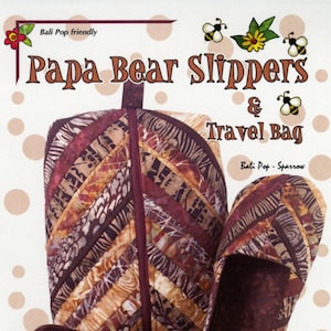 May include: A sewing pattern for a pair of brown and tan slippers and a travel bag. The pattern is called "Papa Bear Slippers & Travel Bag" and is by Gersi Richards. The pattern is Bali Pop friendly and the slippers are for men's sizes 7-14.