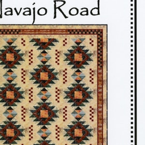May include: A quilt pattern called "Navajo Road" by "Whirligig Designs". The pattern features a geometric design with red, orange, blue, and green colors on a beige background.