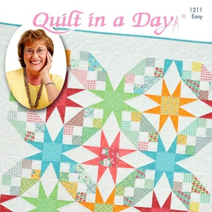 May include: A quilt pattern featuring a colorful star design with a white background. The pattern is titled "Roundabout Stars Quilt" and is by Eleanor Burns. The pattern is labeled "Quilt in a Day" and "Easy".