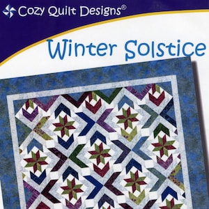 May include: A quilt pattern for a Winter Solstice quilt, designed by Georgette Dell'Orco. The pattern uses 2 1/2 inch strips and is great for using with the Strip Tube Ruler or Strip Tube Junior. The quilt is made up of a variety of colors, including red, green, blue, and purple.