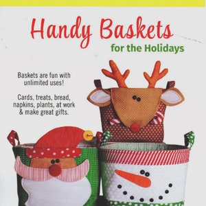 May include: Three Christmas-themed fabric baskets with Santa, snowman, and reindeer faces. The baskets are 6 inches tall, 8 inches wide, and 8 inches deep. Handy Baskets for the Holidays.