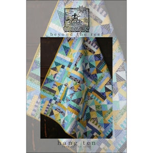May include: A colorful quilt with a patchwork design featuring various shades of blue, yellow, and green. The quilt has geometric patterns and the text "beyond the reef" and "hang ten toes on the nose".