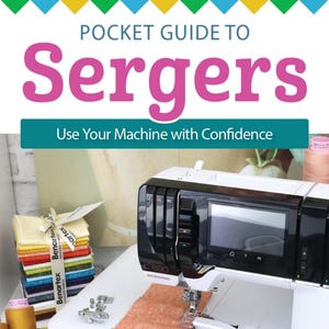May include: A white serger sewing machine with a black control panel is shown with a piece of orange fabric being sewn. The image includes a book titled "Pocket Guide to Sergers" and spools of thread in a basket.