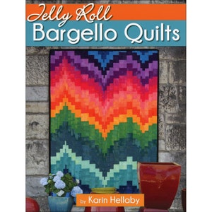 May include: A colorful quilt with a chevron pattern in shades of purple, red, orange, green, blue, and teal. The quilt is titled "Jelly Roll Bargello Quilts" by Karin Hellaby.