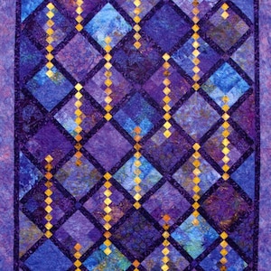 May include: A quilt with a diamond pattern in shades of purple and blue with gold accents.