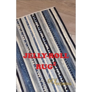 May include: A blue and white striped rug with a "Jelly-Roll Rug" label. The rug is made from fabric scraps and has a unique, handmade look.