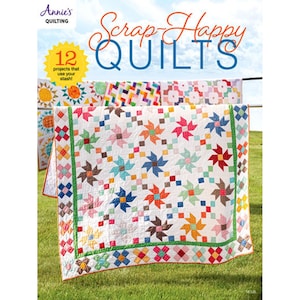 May include: A colorful quilt book cover with the title "Scrap-Happy Quilts" and the Annie's Quilting logo. The image features several quilts with star and geometric patterns, displayed outdoors on a clothesline. The book cover states "12 projects that use your stash!"