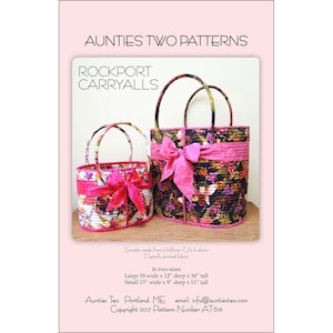 May include: Two quilted fabric bags with pink ribbon handles. The larger bag is 18 inches wide by 12 inches deep by 16 inches tall. The smaller bag is 13 inches wide by 9 inches deep by 11 inches tall. The bags are made from Hoffman CA Fabrics digitally printed fabric. The pattern is called Rockport Carryalls. Copyright 2017 Pattern Number AT615.