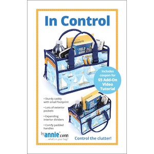 May include: A blue and white fabric tote bag with a sailboat pattern. The bag is filled with various items, including a water bottle, a book, and a remote control. The bag has a sturdy handle and a small footprint. The text "In Control" is printed in large letters at the top of the image. The text "Control the clutter!" is printed at the bottom of the image. The text "byannie.com" is printed in the lower left corner of the image.