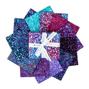 May include: A collection of colorful fabric squares arranged in a circular pattern. The fabrics feature a batik-style design with shades of blue, purple, red, and teal. A wrapped gift box with a white ribbon is in the center, with the text "Expressly Colorful".