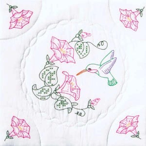 May include: White quilted square with embroidered pink morning glories and a green hummingbird. The central design features a hummingbird approaching a flower, surrounded by more flowers and leaves. Additional flowers are in each corner.