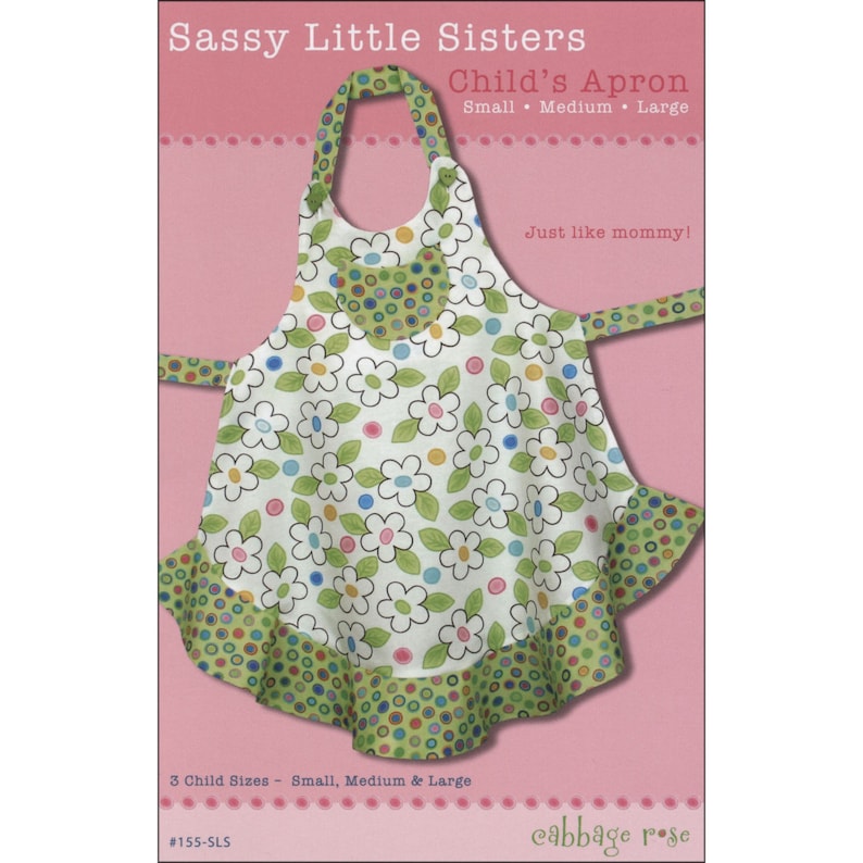 May include: A sewing pattern for a child's apron with a floral print and green polka dots. The pattern is called "Sassy Little Sisters Child's Apron" and includes three sizes: small, medium, and large. The pattern is from Cabbage Rose.