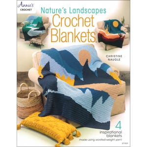 May include: A book cover titled "Nature's Landscapes Crochet Blankets" by Annie's Crochet. The cover features images of four landscape-themed crochet blankets. The main image shows a blue, tan, and yellow blanket draped over a beige chair. A yellow pillow with tassels is in the foreground.
