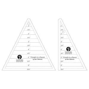 May include: Two clear acrylic quilting rulers for creating triangle-in-a-square blocks. The left ruler is an isosceles triangle, the right is a right triangle. Both feature printed markings from 1 inch to 6.5 inches and the Planted Seed Designs logo.