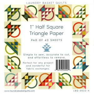 May include: A pack of 40 sheets of 1 inch half square triangle paper for quilting. The paper is designed to make cutting and sewing triangles easier. The pack is labeled "Laundry Basket Quilts" and has a barcode.