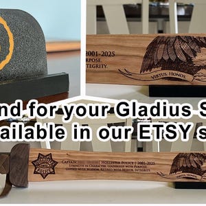 May include: A black stand with an orange flame logo, and a wooden sword with a carved eagle and text. The image also shows a wooden sword with a police badge and text. The text says "Stand for your Gladius Sword available in our ETSY store."