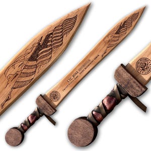 May include: A wooden sword with a brown leather handle and a wood-burned American flag design. The sword is engraved with "LTC JOSE - UNITED STATES ARMY - HAPPY RETIREMENT SENIOR".